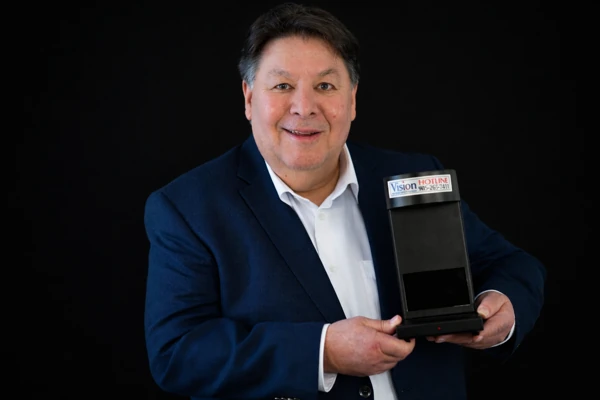 Barry Kruger, founder of Tellervision Business Solutions, holding a Vision counterfeit detector