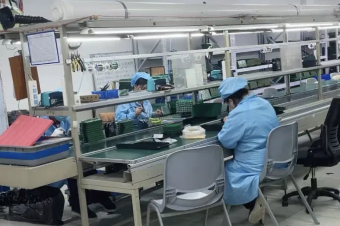 Technicians at the component insertion line assembling circuit boards for the Vision detector