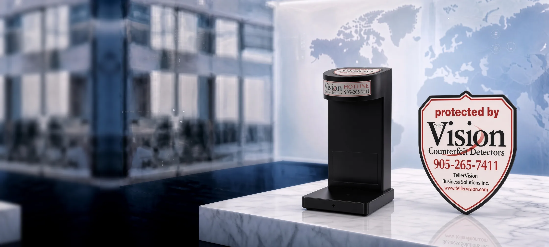 A Vision counterfeit detector beside the 'Protected by Teller Vision' window shield on a marble counter, a world map behind it